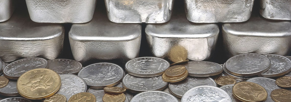 stack of silver bars and gold coins